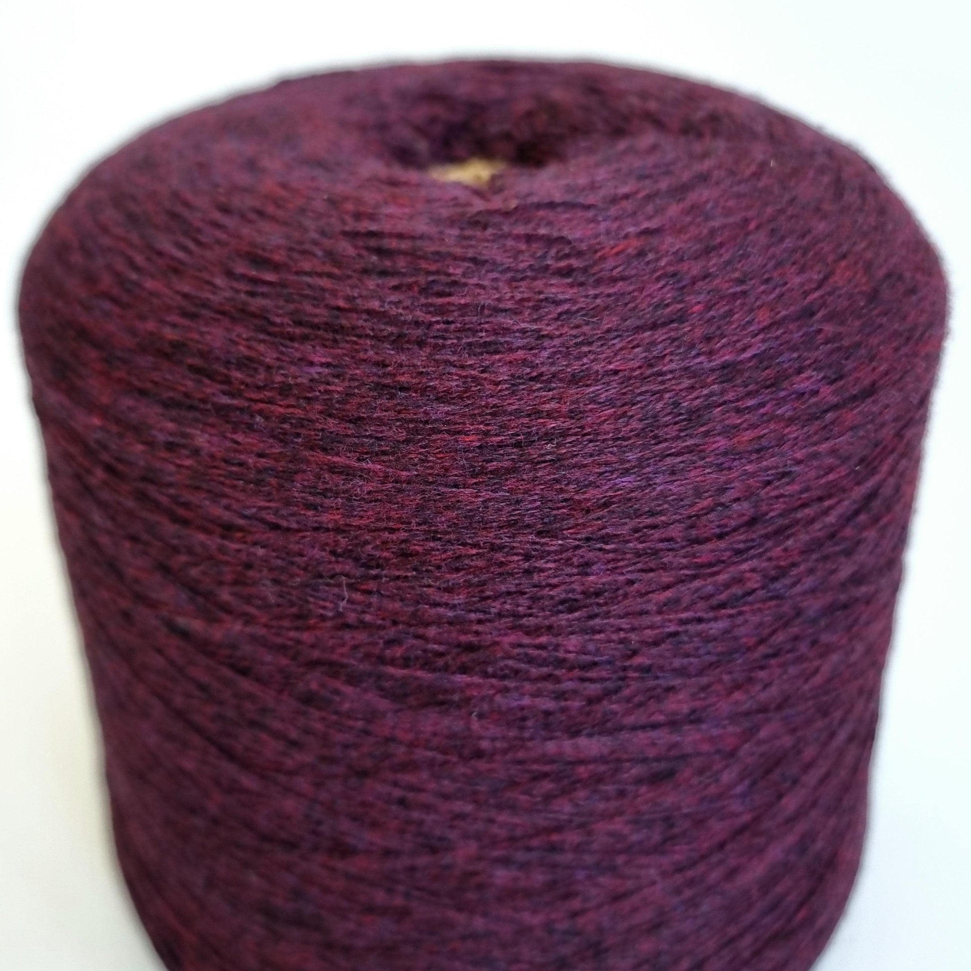 Purple yarn ball on a white background